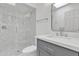 Modern bathroom featuring a sleek gray vanity, and glass enclosed shower with hexagon tile at 220 N 22Nd Pl # 2036, Mesa, AZ 85213