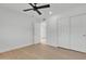 Clean bedroom features wood flooring, ceiling fan, and closet with sliding doors at 220 N 22Nd Pl # 2036, Mesa, AZ 85213