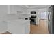 Kitchen with white cabinets, modern appliances, a view to the balcony, and wood flooring at 220 N 22Nd Pl # 2036, Mesa, AZ 85213
