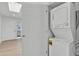 Compact laundry room with stacked washer and dryer next to a door to the exterior at 220 N 22Nd Pl # 2036, Mesa, AZ 85213