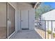 Outdoor patio with textured walls and a view of the green foliage beyond the railing at 220 N 22Nd Pl # 2036, Mesa, AZ 85213
