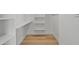 Bright walk-in closet with built in shelving and hardwood floors at 220 N 22Nd Pl # 2036, Mesa, AZ 85213