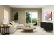 Bright living room with modern decor, a sliding glass door, and a view of the outdoor patio at 23219 W Marguerite Ave, Buckeye, AZ 85326