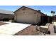 View of a single Gathering home featuring a two-car garage, desert landscaping, and a neutral color scheme at 3027 W Zachary Dr, Phoenix, AZ 85027