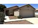 Single-story home featuring a neutral color scheme, two-car garage, and desert landscaping for a modern look at 3027 W Zachary Dr, Phoenix, AZ 85027