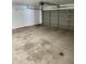 Spacious garage with a neutral gray door and storage shelves, offering ample room for parking and storage at 3329 W Ross W Ave, Phoenix, AZ 85027