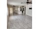 Open living room with tile floors and a view into the kitchen, creating a seamless and modern living space at 3329 W Ross W Ave, Phoenix, AZ 85027