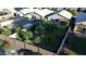 Aerial view of backyard featuring a large grassy area, privacy fence and mature trees at 3404 E Lavey Ln, Phoenix, AZ 85032