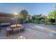 Paver backyard featuring a seating area, mature trees and a trellis at 3404 E Lavey Ln, Phoenix, AZ 85032
