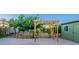 Backyard with a wooden pergola, custom shed, garden, and trees at 3404 E Lavey Ln, Phoenix, AZ 85032