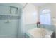 Charming bathroom featuring a soaking tub, tiled shower, and arched window at 3404 E Lavey Ln, Phoenix, AZ 85032