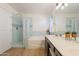 Bright bathroom featuring dual sinks, white countertops, and decorative lighting at 3404 E Lavey Ln, Phoenix, AZ 85032