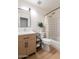Modern bathroom featuring wood-look vanity and shower-tub combination at 3404 E Lavey Ln, Phoenix, AZ 85032