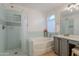 Well-lit bathroom showcasing a tiled shower and separate soaking tub at 3404 E Lavey Ln, Phoenix, AZ 85032