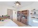 Bright bedroom featuring built-in shelving, wood-look flooring and barn style sliding door at 3404 E Lavey Ln, Phoenix, AZ 85032