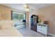 Bright bedroom with a ceiling fan, desk near window and storage furniture at 3404 E Lavey Ln, Phoenix, AZ 85032