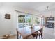 Bright dining room features a wooden table, chairs, and sliding doors to the backyard at 3404 E Lavey Ln, Phoenix, AZ 85032