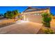 Single story home featuring a two-car garage and low maintenance desert landscaping at 3404 E Lavey Ln, Phoenix, AZ 85032
