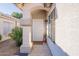 Inviting front entrance with decorative door and well-maintained landscaping, flower, and neutral toned porch at 3404 E Lavey Ln, Phoenix, AZ 85032