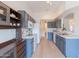 Traditional kitchen with blue cabinets, white appliances, and neutral countertops at 3404 E Lavey Ln, Phoenix, AZ 85032