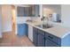 Close up view of the kitchen sink and countertop with painted cabinets at 3404 E Lavey Ln, Phoenix, AZ 85032