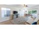 Living room features wood floors, ceiling fan, neutral paint, and large backyard-facing windows at 3404 E Lavey Ln, Phoenix, AZ 85032