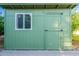 A green storage shed with a window and door at 3404 E Lavey Ln, Phoenix, AZ 85032