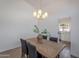 Cozy dining room features an elegant chandelier and a wooden table with seating for four at 3608 W Fairview Ln, Chandler, AZ 85226