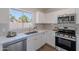 Well-lit kitchen boasts modern appliances, white cabinets, quartz countertops, and a subway tile backsplash at 3608 W Fairview Ln, Chandler, AZ 85226