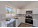Well-lit kitchen boasts modern appliances, white cabinets, quartz countertops, and a subway tile backsplash at 3608 W Fairview Ln, Chandler, AZ 85226