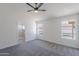 Bright bedroom with a ceiling fan, carpeted floors, and natural light from dual windows overlooking the pool at 3608 W Fairview Ln, Chandler, AZ 85226