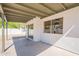 This covered patio features desert landscaping, stucco walls and sliding glass doors at 3608 W Fairview Ln, Chandler, AZ 85226