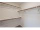 Spacious walk-in closet equipped with wooden rod shelving for maximum storage at 3608 W Fairview Ln, Chandler, AZ 85226