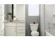 Bathroom with white cabinets, modern fixtures, and a bright window at 36520 W Maddaloni Ave, Maricopa, AZ 85138