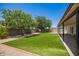 Large backyard with a well-maintained lawn and covered patio, perfect for entertaining at 3839 E Friess Dr, Phoenix, AZ 85032