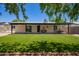 Backyard features a well-maintained lawn, covered patio, and mature trees for shade at 3839 E Friess Dr, Phoenix, AZ 85032