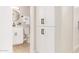 Hallway view of updated bathroom with white cabinets and black hardware, next to linen closet at 3839 E Friess Dr, Phoenix, AZ 85032