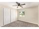 Bedroom featuring a ceiling fan, closet, and a large window at 3839 E Friess Dr, Phoenix, AZ 85032