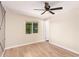 Bright bedroom with wood-look tile flooring and a view of the outdoors at 3839 E Friess Dr, Phoenix, AZ 85032