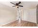 Bedroom features a ceiling fan, tile floors, and a closet with white doors at 3839 E Friess Dr, Phoenix, AZ 85032