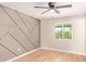 Bedroom features a neutral-toned accent wall and tile floors at 3839 E Friess Dr, Phoenix, AZ 85032