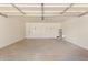 Spacious garage with painted walls, door to the backyard, and ample room for parking at 3839 E Friess Dr, Phoenix, AZ 85032