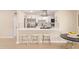 Modern kitchen with stainless steel appliances, white cabinets, and a stylish breakfast bar at 3839 E Friess Dr, Phoenix, AZ 85032
