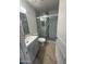 Stylish bathroom with updated vanity, toilet, and shower with decorative tile accents at 3844 N 88Th Ln, Phoenix, AZ 85037