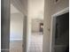 Hallway view towards the kitchen and dining area, showcasing the open layout at 3844 N 88Th Ln, Phoenix, AZ 85037