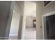 Hallway with vaulted ceilings leading to an open kitchen and dining area at 3844 N 88Th Ln, Phoenix, AZ 85037