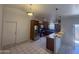 Kitchen with stainless steel appliances, wooden cabinets, and white tile floor at 3844 N 88Th Ln, Phoenix, AZ 85037