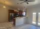 Bright kitchen with an island, stainless steel appliances, and pendant lighting at 3844 N 88Th Ln, Phoenix, AZ 85037