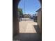 View from the arched porch showing a brick walkway to the driveway at 3844 N 88Th Ln, Phoenix, AZ 85037