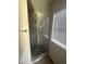 Updated shower featuring marble tile, mosaic accents, and a frameless glass door at 3844 N 88Th Ln, Phoenix, AZ 85037